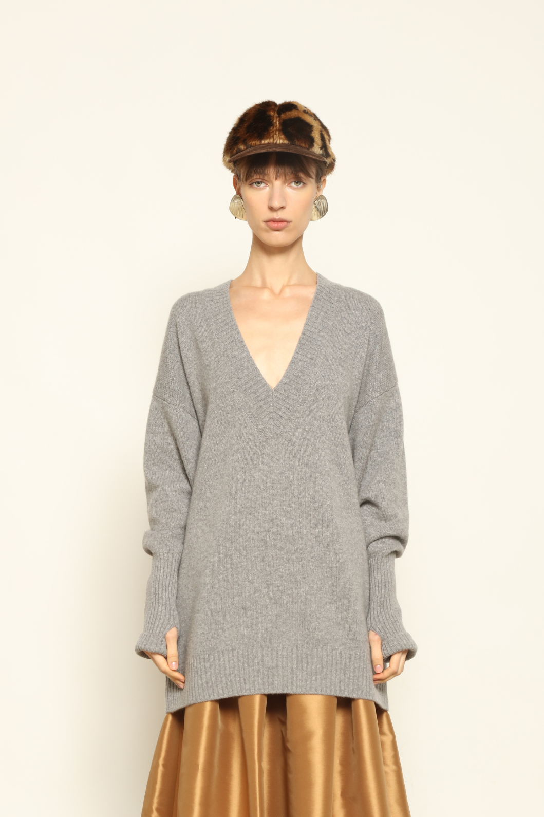 Model wearing the Graphite Nina V-Neck Long Sweater by House of Nomad Stories, crafted in Italy from 100% pure Inner Mongolia cashmere, featuring a deep graphite hue, elongated silhouette, soft drape, and timeless sustainable knitwear design