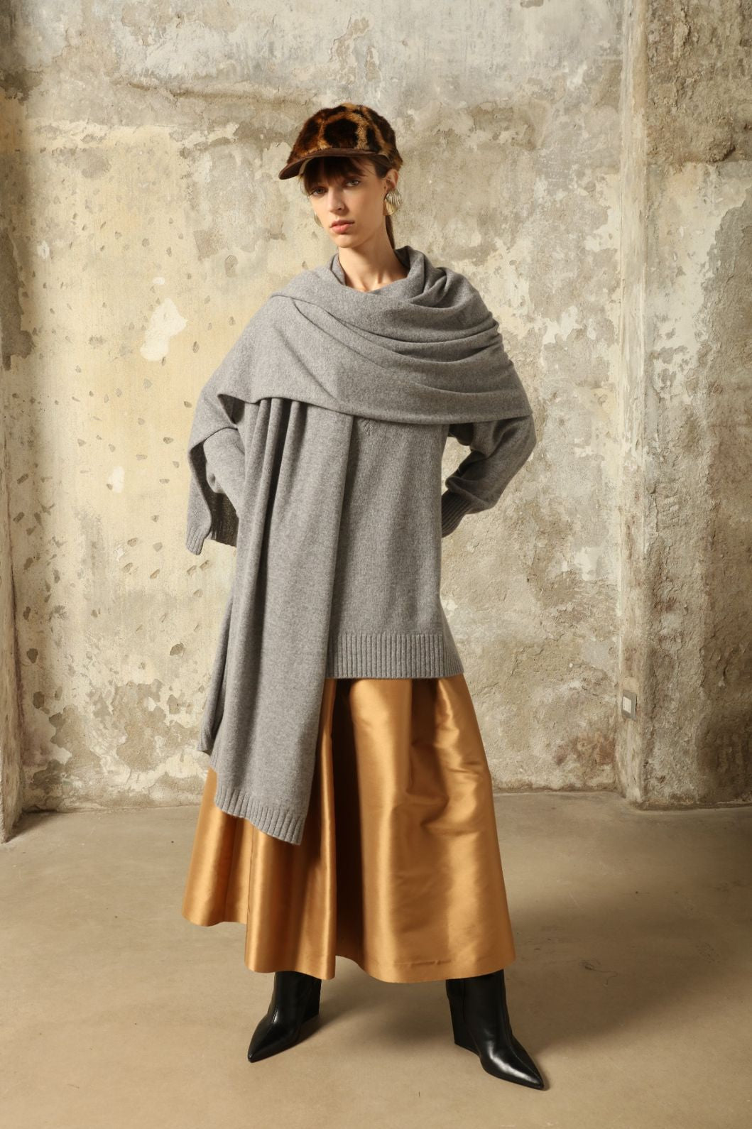 Model wearing the Graphite Nina V-Neck Long Sweater by House of Nomad Stories, crafted in Italy from 100% pure Inner Mongolia cashmere, featuring a deep graphite hue, elongated silhouette, soft drape, and timeless sustainable knitwear design