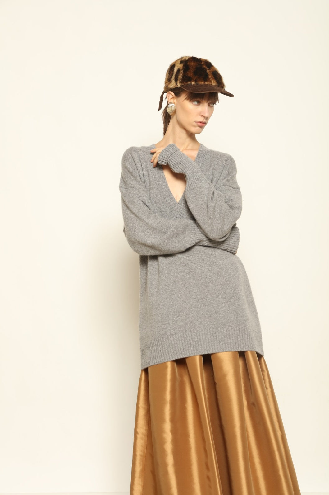Model wearing the Graphite Nina V-Neck Long Sweater by House of Nomad Stories, crafted in Italy from 100% pure Inner Mongolia cashmere, featuring a deep graphite hue, elongated silhouette, soft drape, and timeless sustainable knitwear design