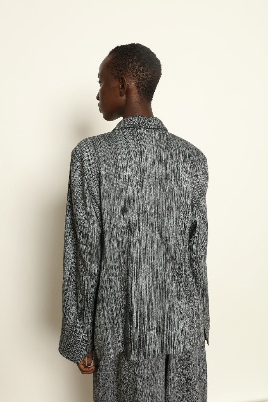 Model is wearing the Grey Chambray Blazer by Marrakshi Life, part of House of Nomad Stories collection, handwoven cotton blazer with relaxed fit, notched collar, and classic tailored details