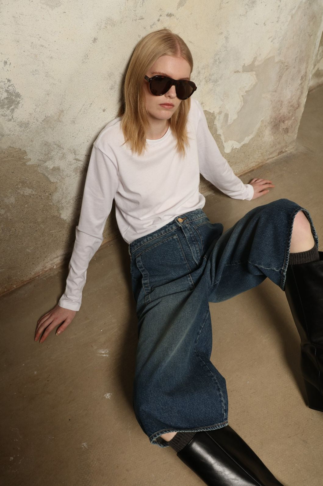 Model is wearing Le Bermuda 4 Poches by Happy Haus, organic denim mid-length bermuda shorts with four oversized patch pockets, curated in the House of Nomad Stories selection.