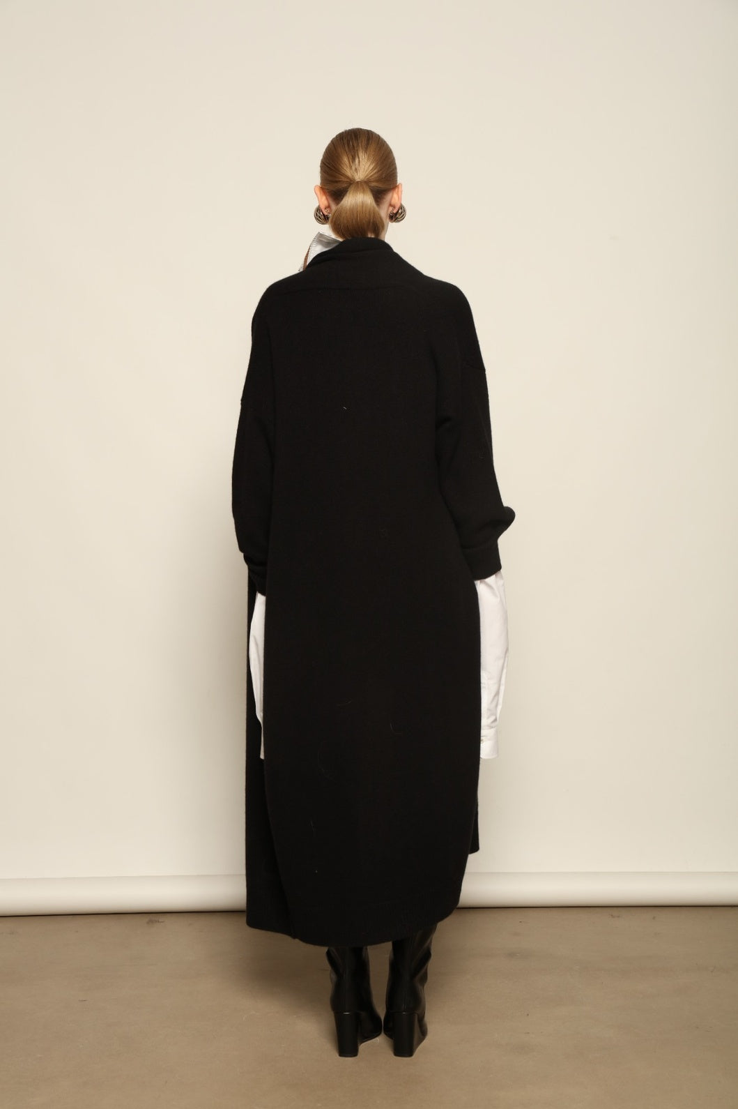 Model is wearing the Black Paula Cashmere Coat by House of Nomad Stories, a pure ethically sourced cashmere coat in deep black with fluid open-front silhouette and refined drape.