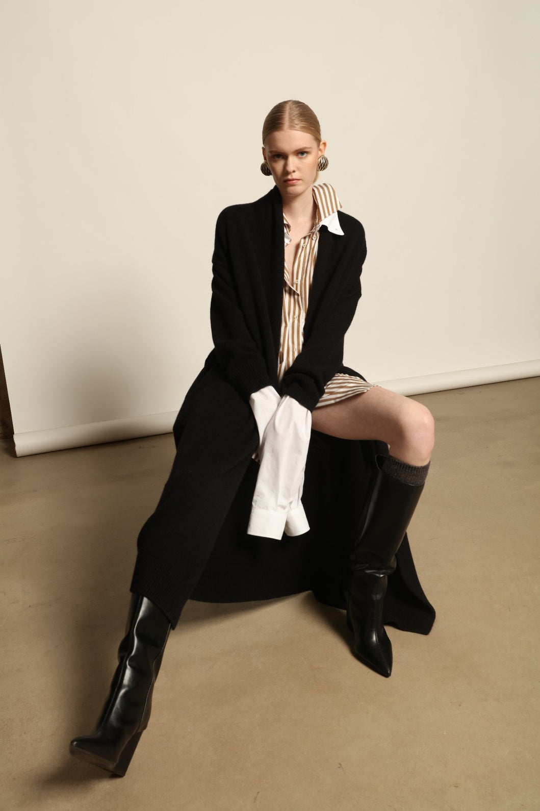 Model is wearing the Black Paula Cashmere Coat by House of Nomad Stories, a pure ethically sourced cashmere coat in deep black with fluid open-front silhouette and refined drape.