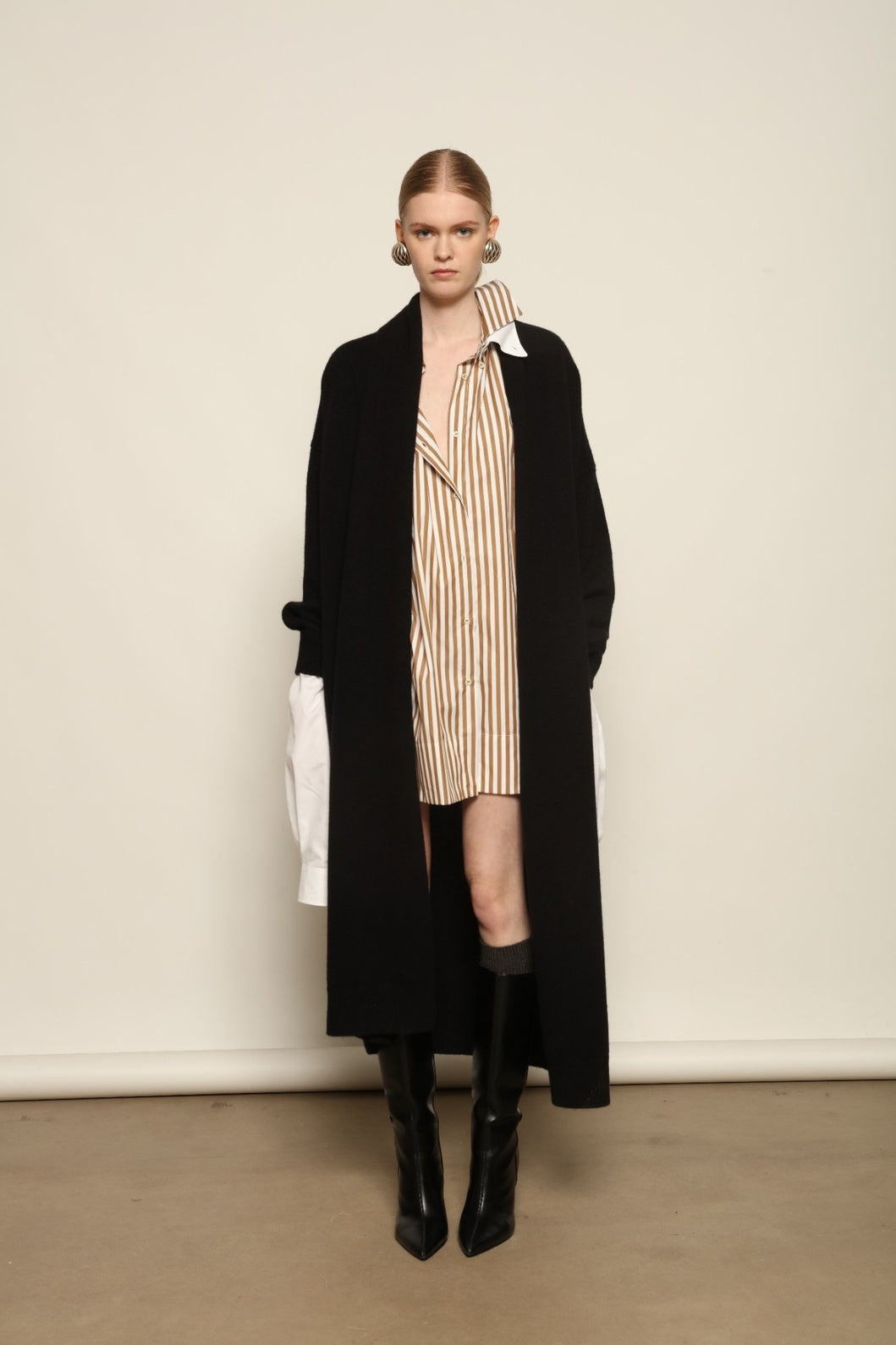 Model is wearing the Black Paula Cashmere Coat by House of Nomad Stories, a pure ethically sourced cashmere coat in deep black with fluid open-front silhouette and refined drape.