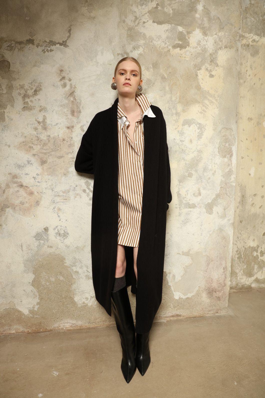 Model is wearing the Black Paula Cashmere Coat by House of Nomad Stories, a pure ethically sourced cashmere coat in deep black with fluid open-front silhouette and refined drape.