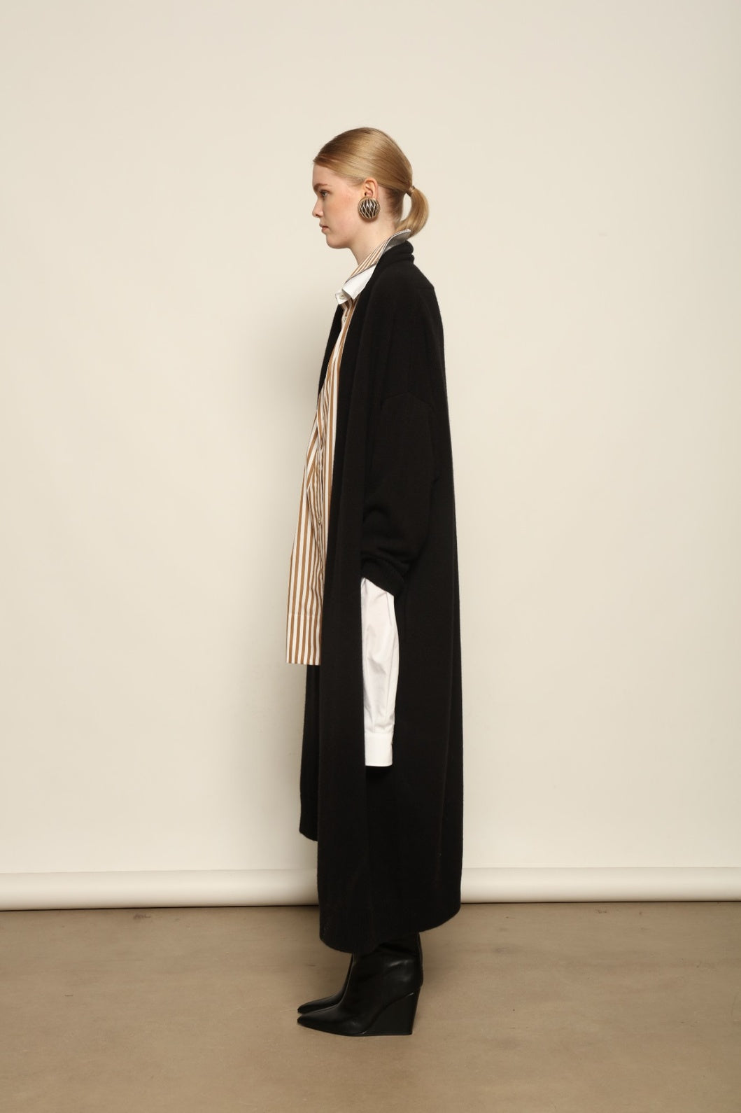 Model is wearing the Black Paula Cashmere Coat by House of Nomad Stories, a pure ethically sourced cashmere coat in deep black with fluid open-front silhouette and refined drape.