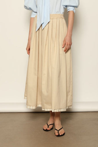 Model wearing the Seoul Camel Skirt by House of Nomad Stories, featuring a structured camel-toned fabric, high-waisted fit, and a clean tailored silhouette with defined architectural lines.