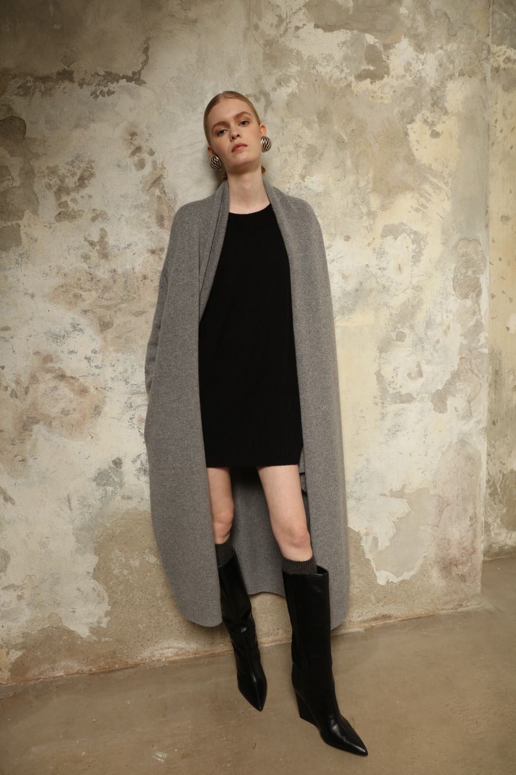 Model is wearing the Graphite Paula Cashmere Coat by House of Nomad Stories, a pure ethically sourced cashmere coat in deep graphite with fluid open-front silhouette and refined soft drape.