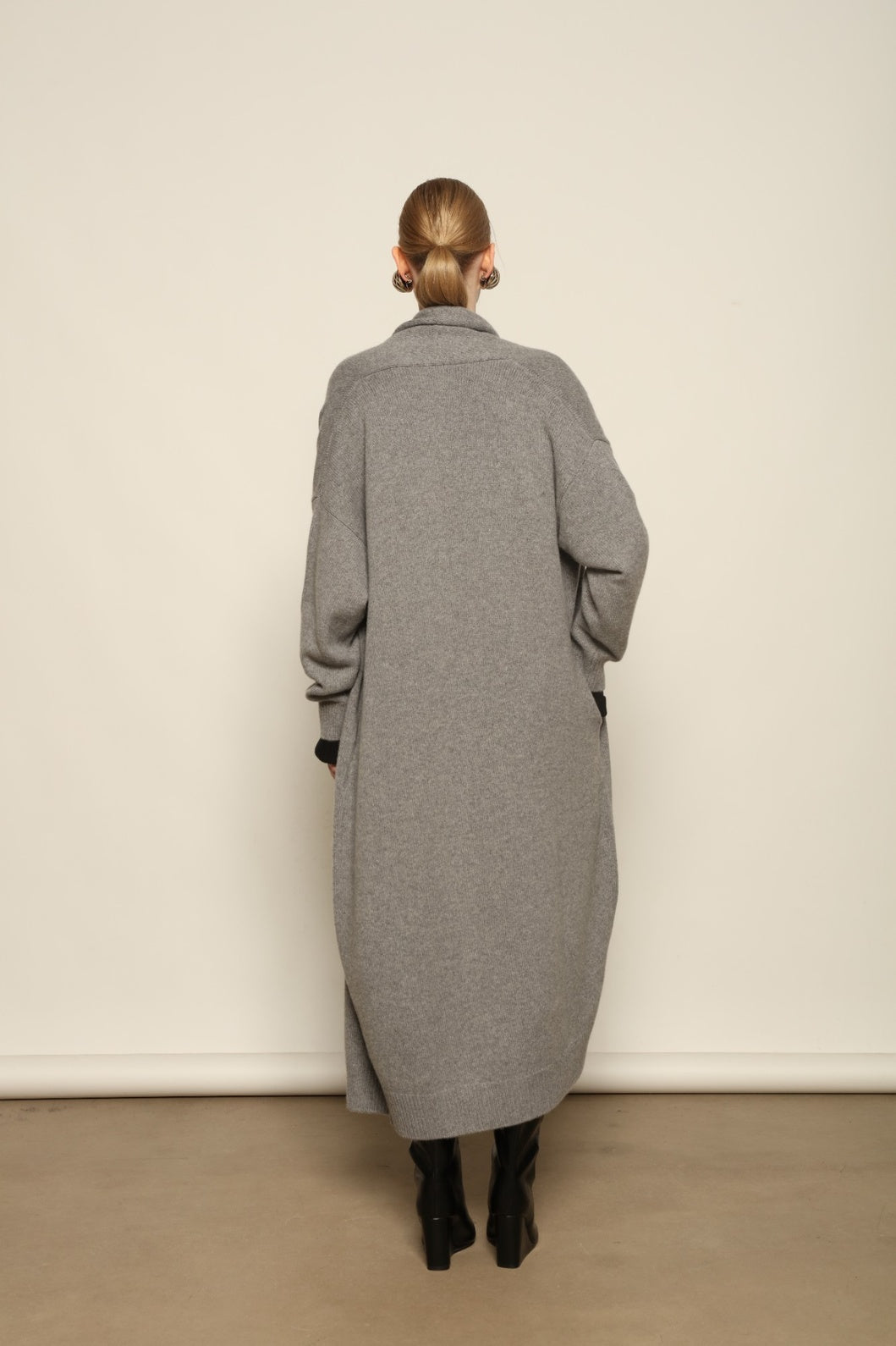 Model is wearing the Graphite Paula Cashmere Coat by House of Nomad Stories, a pure ethically sourced cashmere coat in deep graphite with fluid open-front silhouette and refined soft drape.