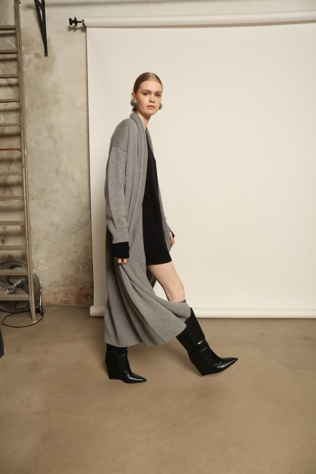 Model is wearing the Graphite Paula Cashmere Coat by House of Nomad Stories, a pure ethically sourced cashmere coat in deep graphite with fluid open-front silhouette and refined soft drape.
