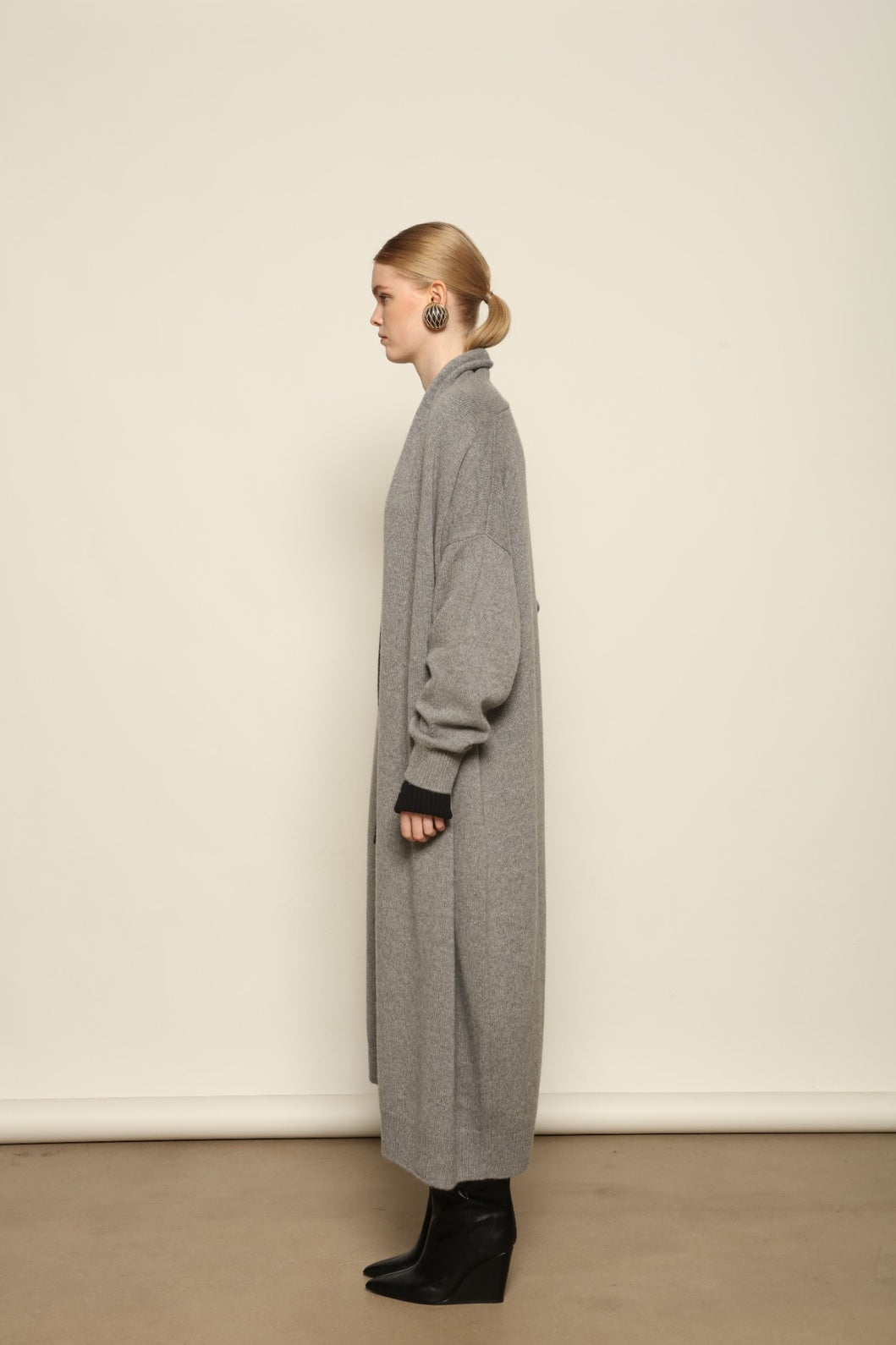 Model is wearing the Graphite Paula Cashmere Coat by House of Nomad Stories, a pure ethically sourced cashmere coat in deep graphite with fluid open-front silhouette and refined soft drape.