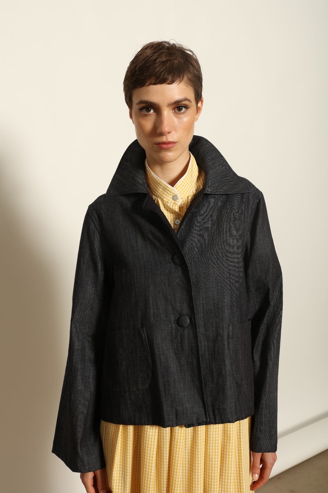 Model wearing the Katharina Ink Denim Jacket by House of Nomad Stories, featuring rich ink-toned denim, relaxed structured silhouette, and refined tailored detailing in premium cotton.