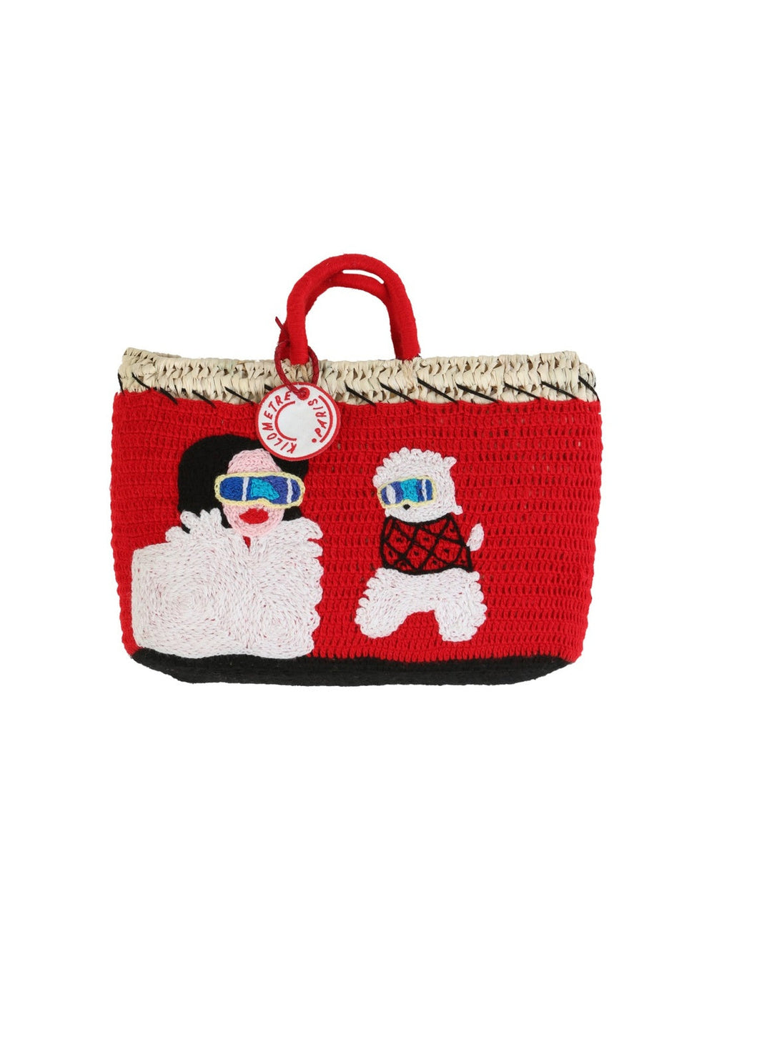 Eleonora & Bijou Undercover basket bag by Kilometre Paris, curated by House of Nomad Stories, featuring red crochet with embroidered winter figures and dog motif on handwoven straw, inspired by Gstaad, travel, and playful craftsmanship