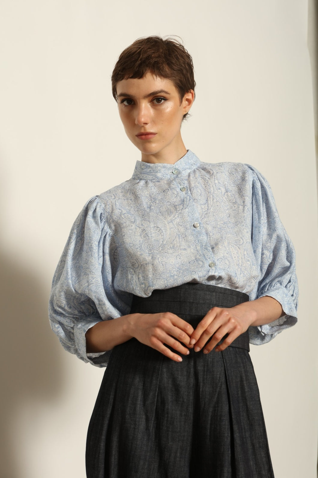 Model wearing the Lola Paisley Blouse by House of Nomad Stories, featuring 100% linen fabric, delicate paisley print, relaxed silhouette, and lightweight breathable summer design.