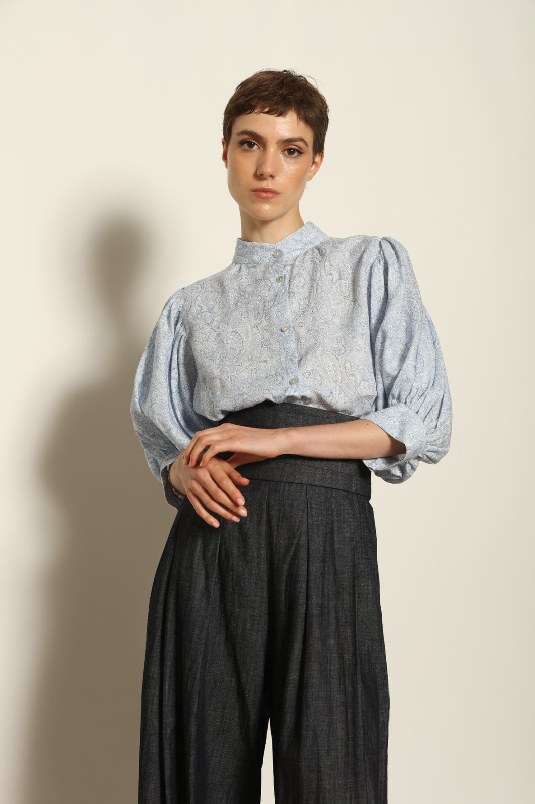 Model wearing the Lola Paisley Blouse by House of Nomad Stories, featuring 100% linen fabric, delicate paisley print, relaxed silhouette, and lightweight breathable summer design.