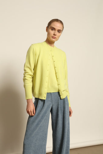 Poppy Yellow Nathalie Coreana pure cashmere cardigan by House of Nomad Stories, with round neckline, long sleeves, and delicate button fastening.