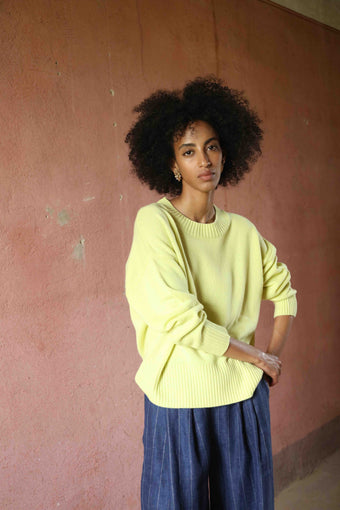 Nena Round Neck Sweater by House of Nomad Stories 100% pure, undyed Inner Mongolian cashmere. Soft, breathable, handcrafted in natural tones. Relaxed fit with ribbed trims. Sustainable luxury knitwear.