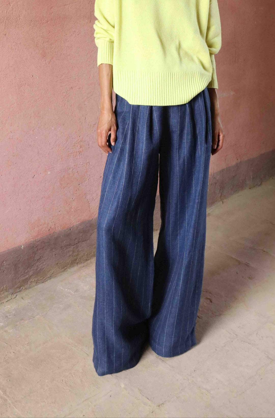 Wide-leg striped trousers in linen, wool, and silk by House of Nomad Stories, featuring a mid-rise elastic waistband, front pleats, and side pockets, handmade in Italy.