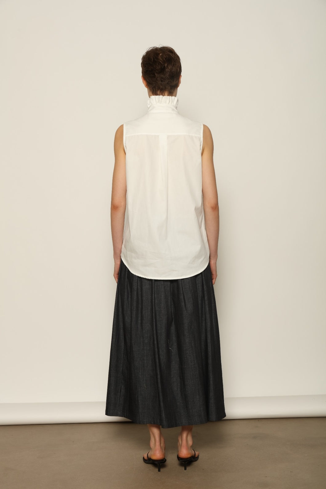 Model wearing the Seoul Ink Denim Skirt by House of Nomad Stories, featuring deep indigo denim, a structured silhouette, and refined tailoring for a timeless and elegant look.