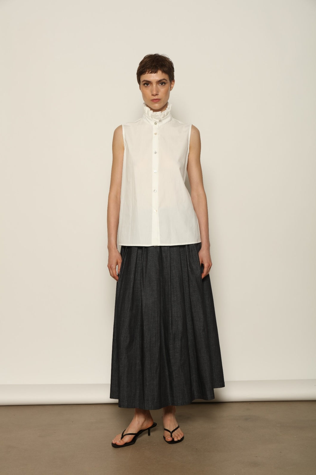 Model wearing the Seoul Ink Denim Skirt by House of Nomad Stories, featuring deep indigo denim, a structured silhouette, and refined tailoring for a timeless and elegant look.