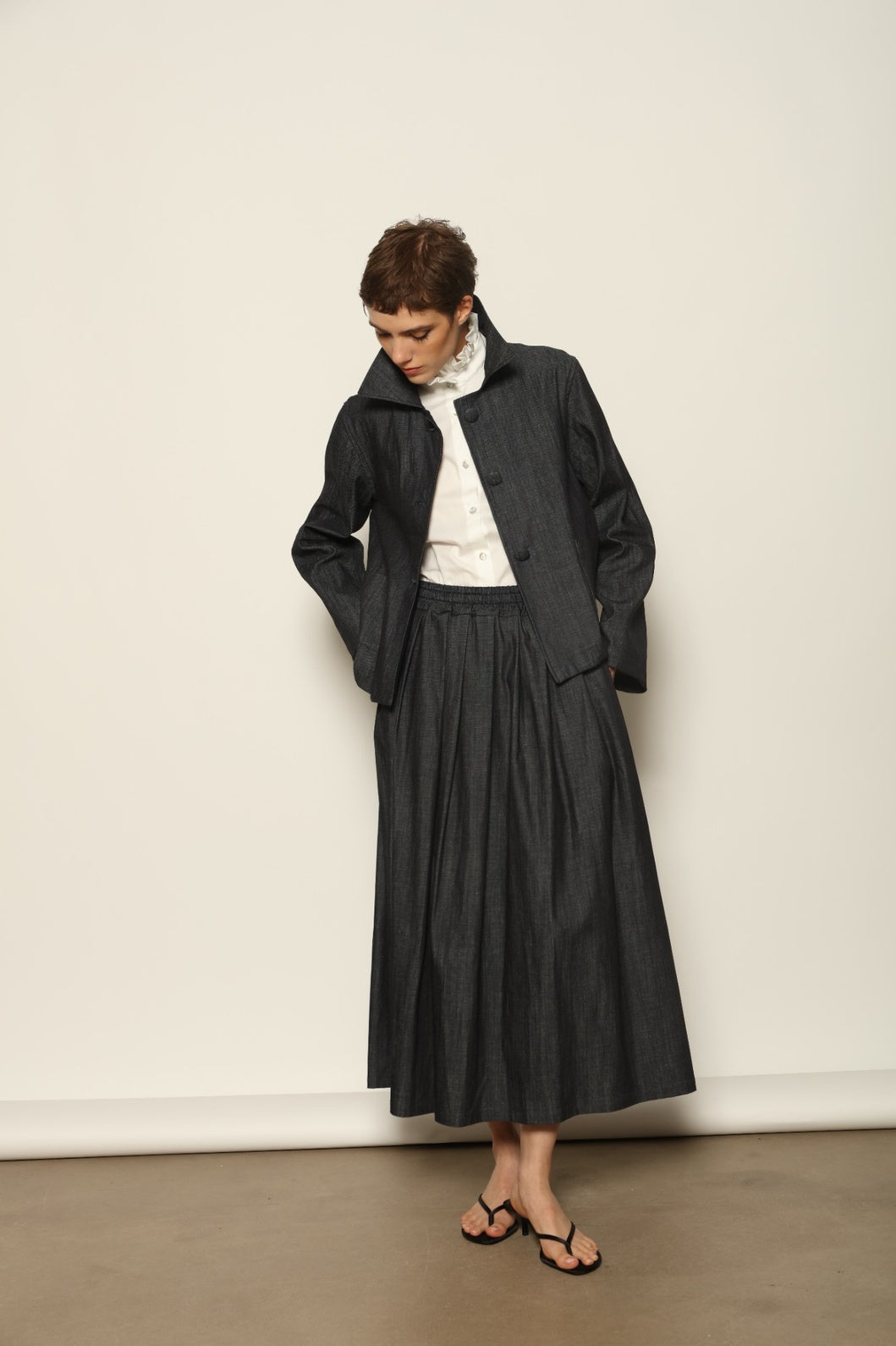 Model wearing the Seoul Ink Denim Skirt by House of Nomad Stories, featuring deep indigo denim, a structured silhouette, and refined tailoring for a timeless and elegant look.