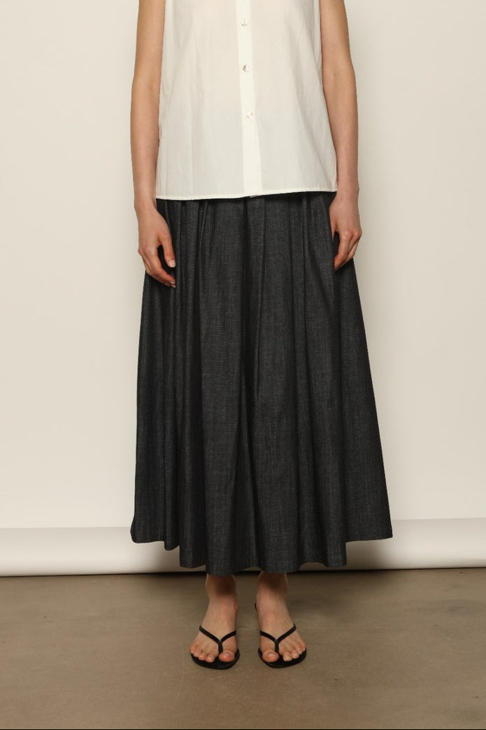 Model wearing the Seoul Ink Denim Skirt by House of Nomad Stories, featuring deep indigo denim, a structured silhouette, and refined tailoring for a timeless and elegant look.