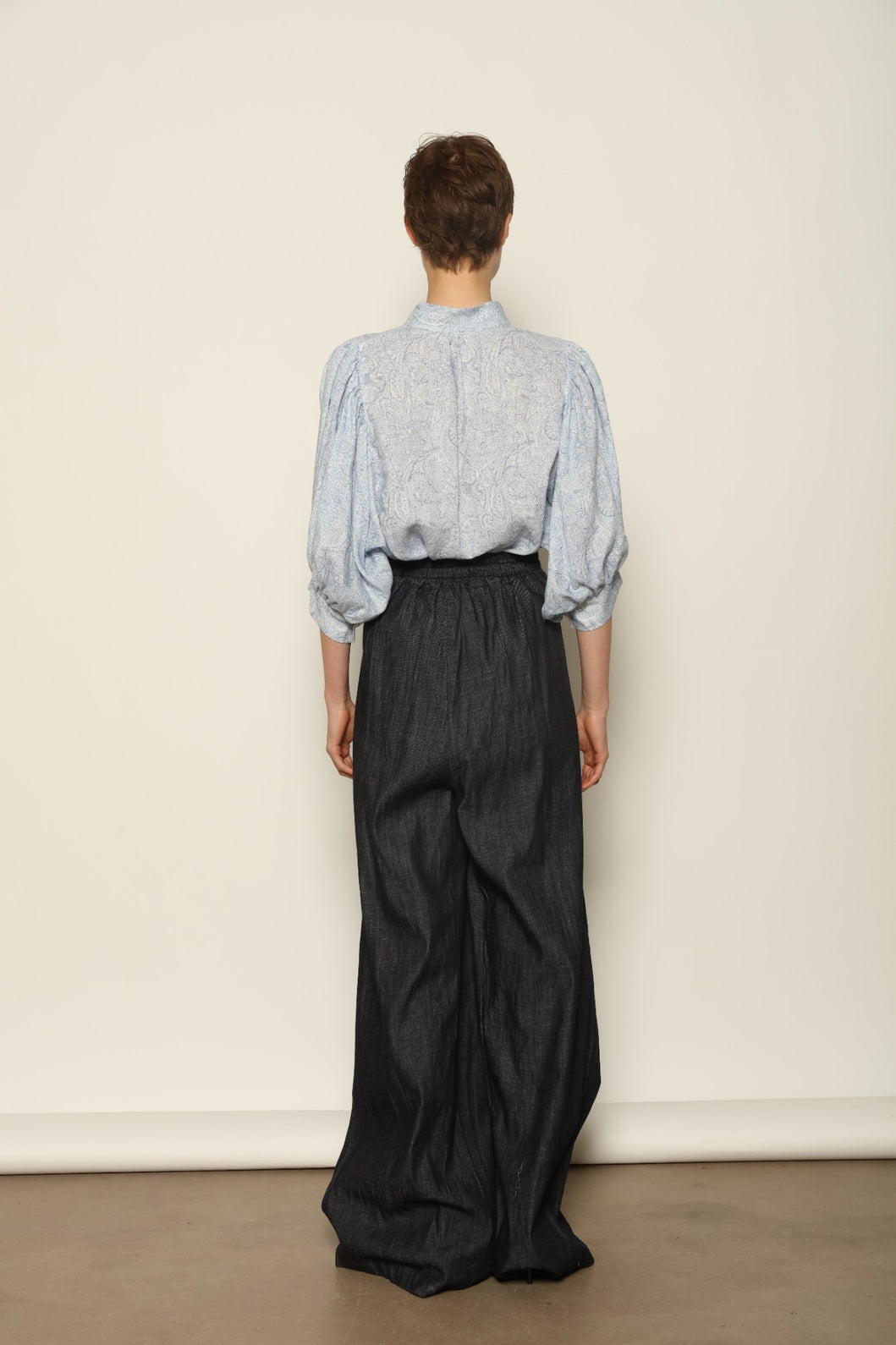 Model wearing the Sergey Night Blue Cummerbund by House of Nomad Stories, featuring a structured silk-wool blend, deep night blue tone, and sculptural waist-defining silhouette.