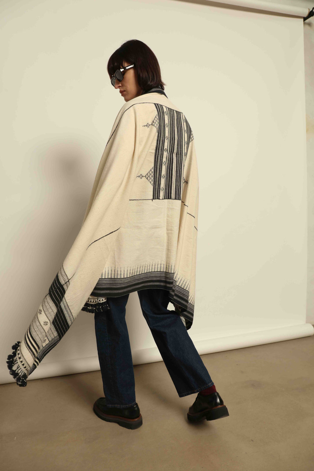 Handwoven Kala cotton throw Ananta by House of Nomad Stories, crafted with handspun yarn and embroidered panels by master weaver Shamji Vankar Vishram Valji in Bhujodi, India.