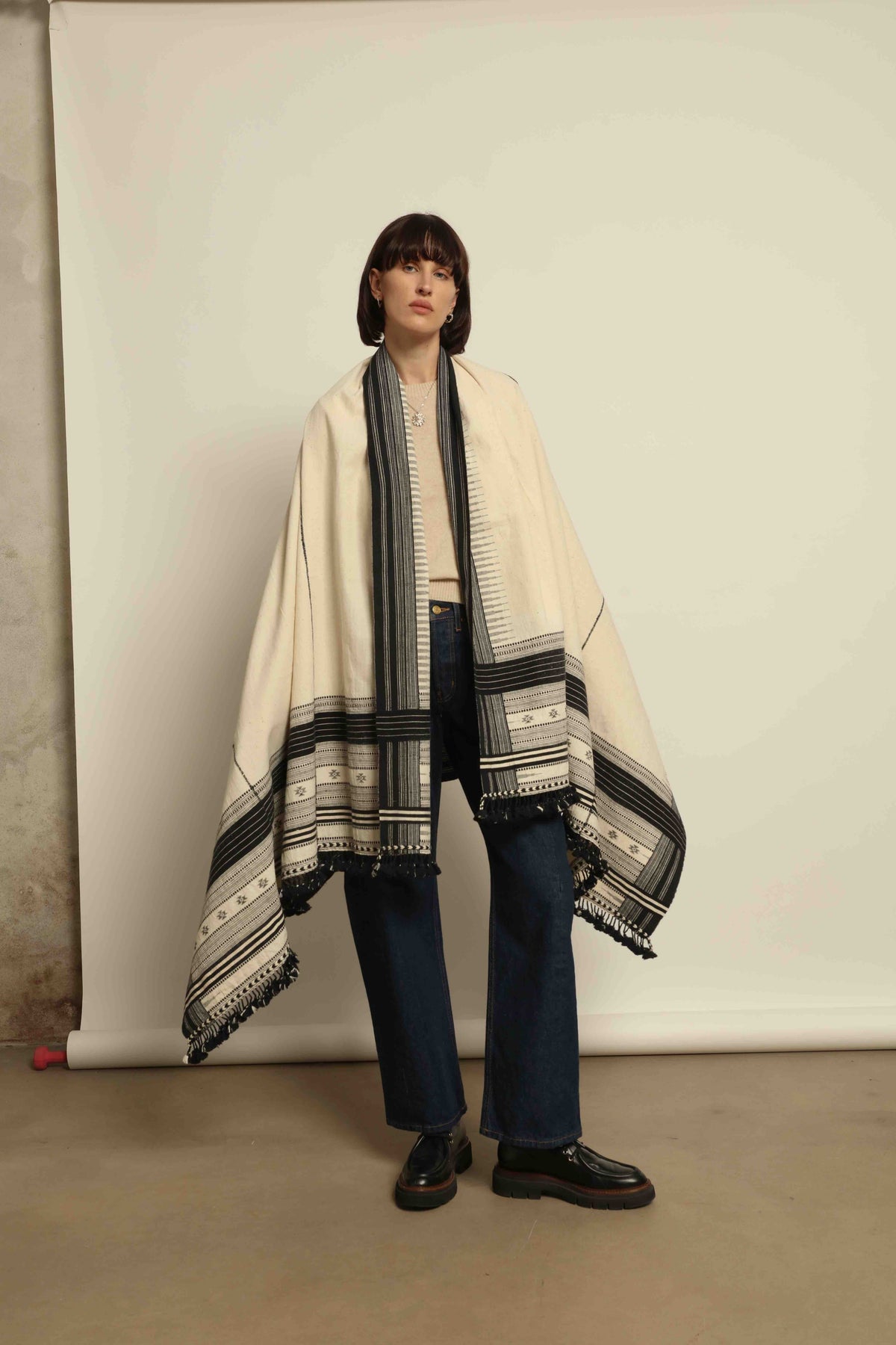 Handwoven Kala cotton throw Ananta by House of Nomad Stories, crafted with handspun yarn and embroidered panels by master weaver Shamji Vankar Vishram Valji in Bhujodi, India.