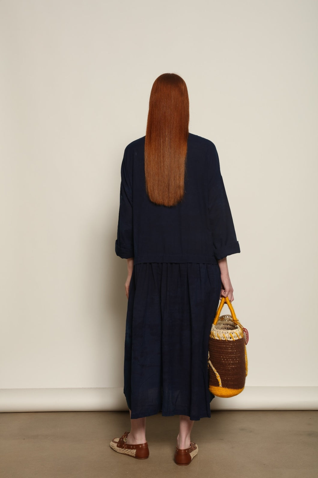 Indigo Marie Dress by House of Nomad Stories, crafted from 100% cotton and hand-dyed with natural indigo in India, featuring a fluid silhouette and unique variations created by the artisanal dyeing process.