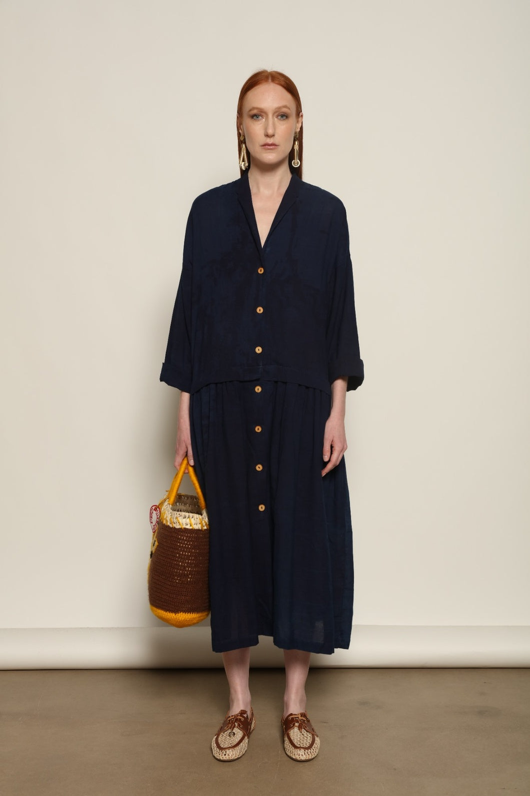 Indigo Marie Dress by House of Nomad Stories, crafted from 100% cotton and hand-dyed with natural indigo in India, featuring a fluid silhouette and unique variations created by the artisanal dyeing process.