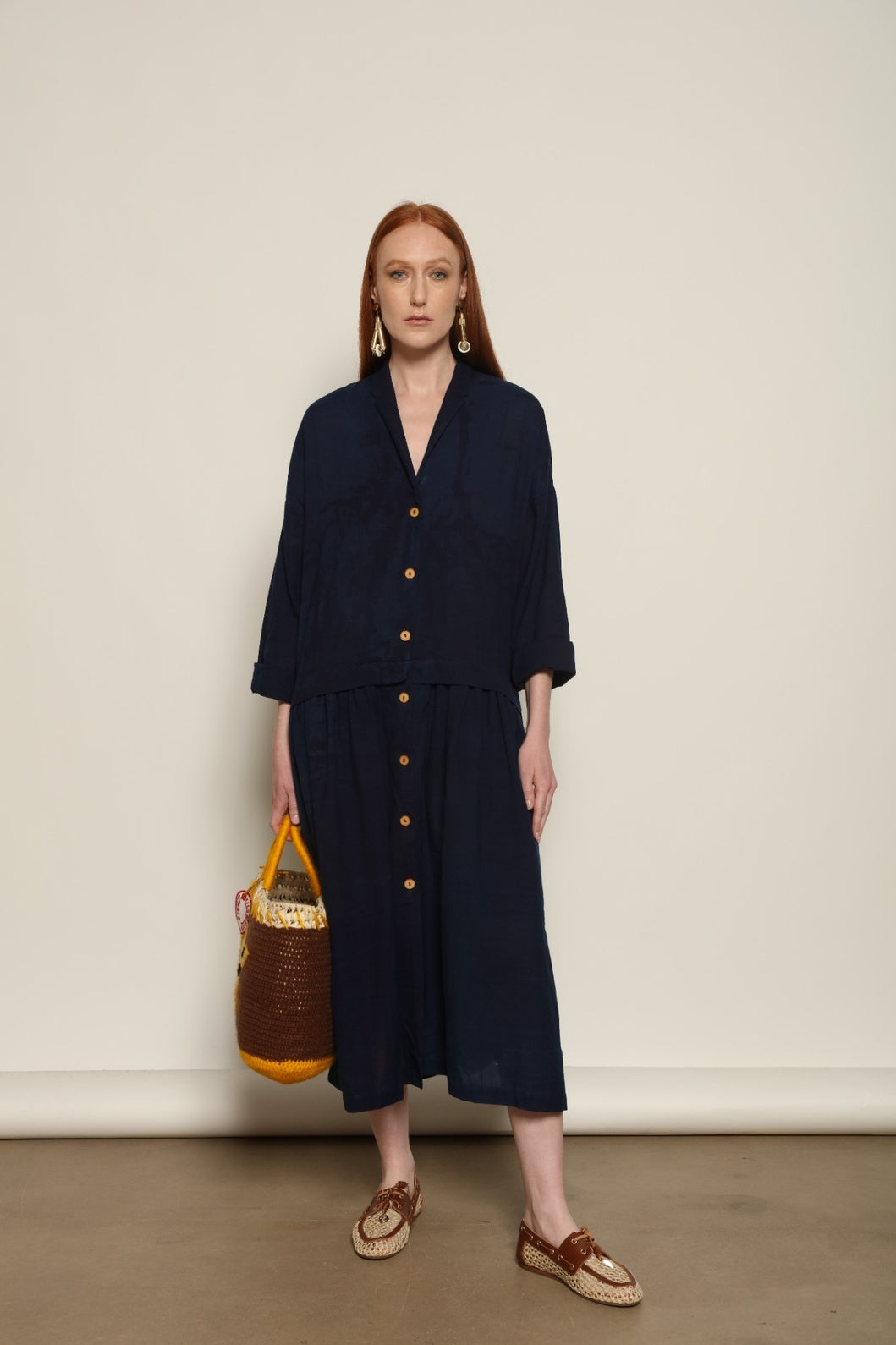 Indigo Marie Dress by House of Nomad Stories, crafted from 100% cotton and hand-dyed with natural indigo in India, featuring a fluid silhouette and unique variations created by the artisanal dyeing process.