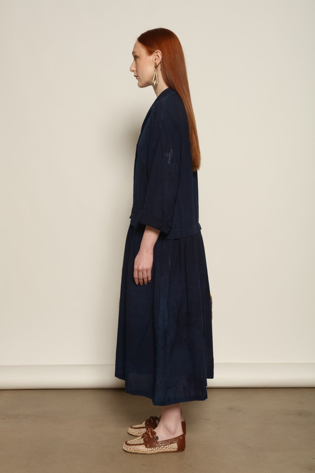 Indigo Marie Dress by House of Nomad Stories, crafted from 100% cotton and hand-dyed with natural indigo in India, featuring a fluid silhouette and unique variations created by the artisanal dyeing process.