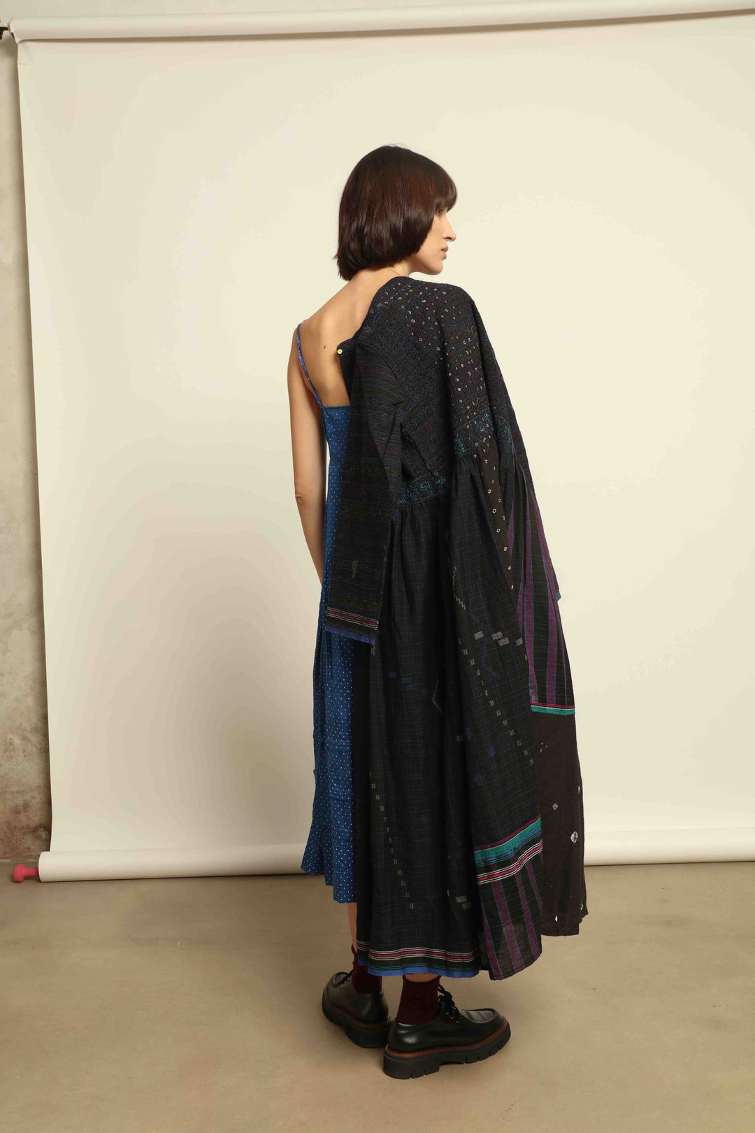 Model is wearing the Folklore 20 dress by Injiri, handmade from silk and wool using traditional Indian handloom techniques, featuring a round neckline, long sleeves, side pockets, and a flattering cut below the bust, curated by House of Nomad Stories.