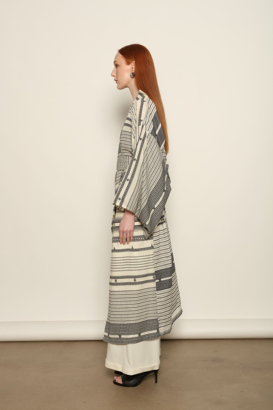 Ink Black Chemena Kimono by House of Nomad Stories, tailor-made in Gujarat from 100% organic Kala cotton, hand-spun for a rich tactile texture, substantial drape, and relaxed wrap silhouette.