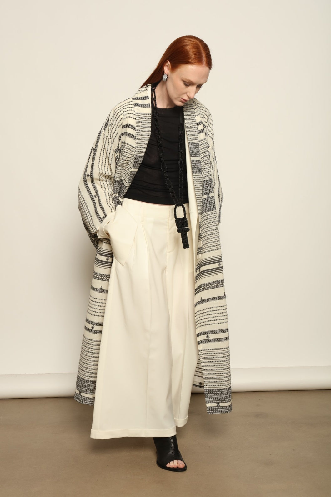 Ink Black Chemena Kimono by House of Nomad Stories, tailor-made in Gujarat from 100% organic Kala cotton, hand-spun for a rich tactile texture, substantial drape, and relaxed wrap silhouette.