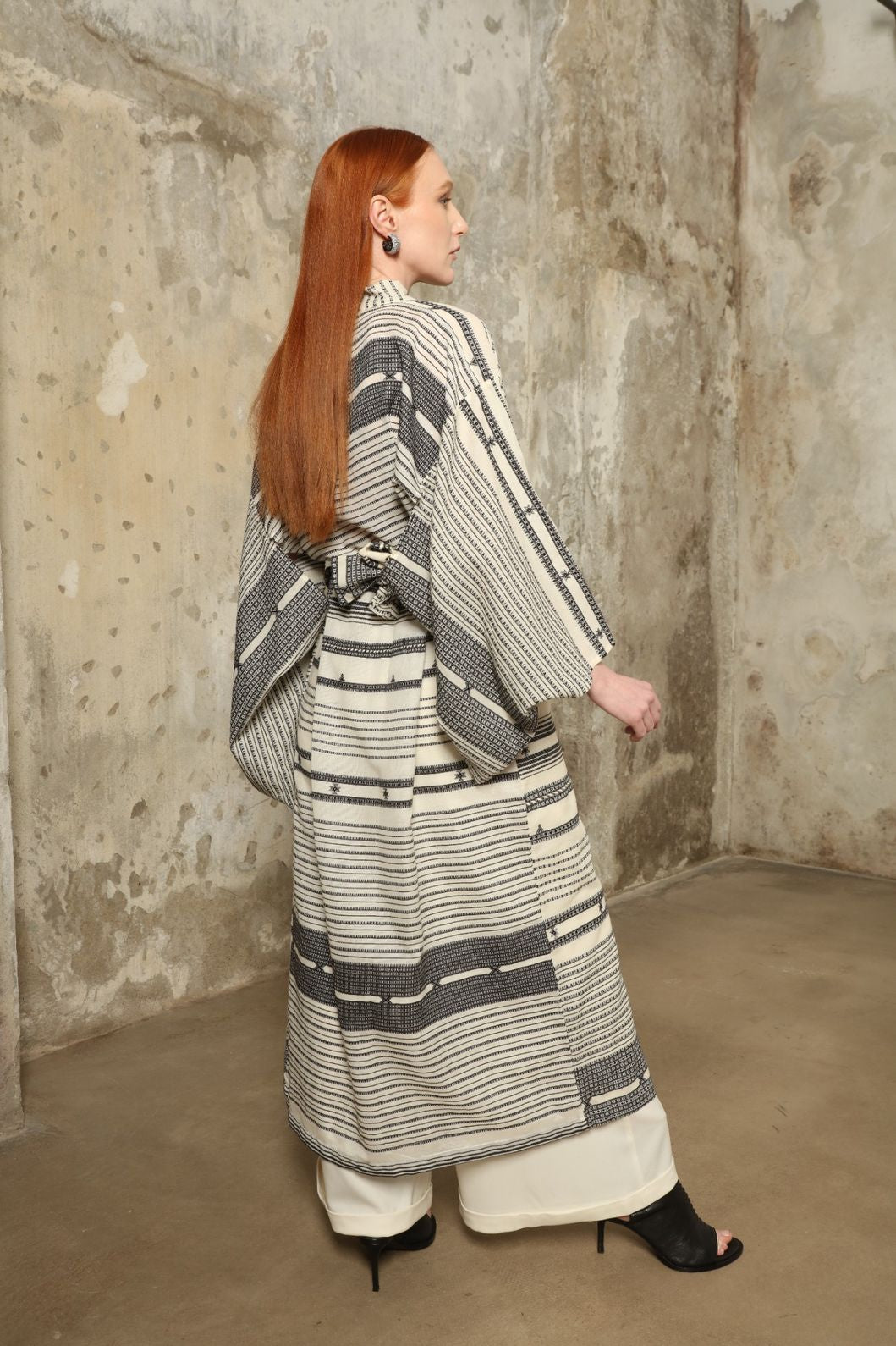 Ink Black Chemena Kimono by House of Nomad Stories, tailor-made in Gujarat from 100% organic Kala cotton, hand-spun for a rich tactile texture, substantial drape, and relaxed wrap silhouette.