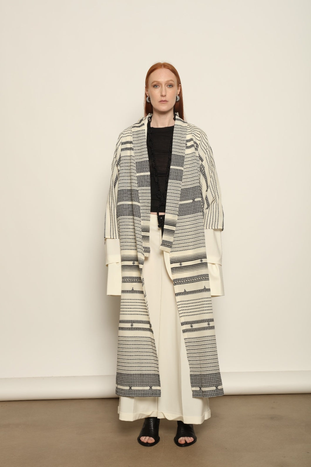 Ink Black Chemena Kimono by House of Nomad Stories, tailor-made in Gujarat from 100% organic Kala cotton, hand-spun for a rich tactile texture, substantial drape, and relaxed wrap silhouette.
