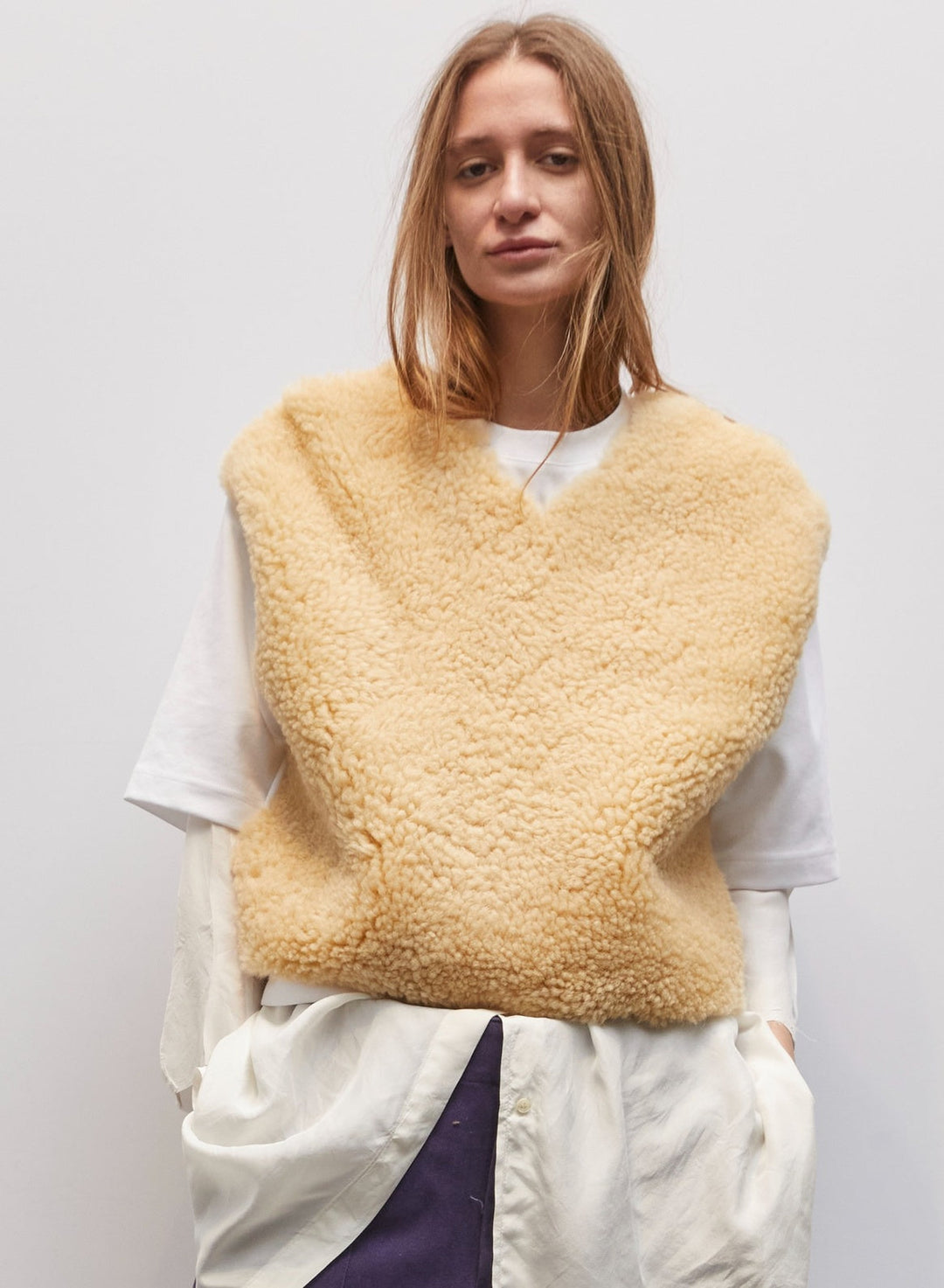 Model wearing the Jejia Cream Mutton V-Neck by Maison Jejia, featuring soft faux mutton fabric, creamy tone, cropped silhouette, clean V-neckline, and cozy layering design, part of the House of Woven Stories Selection