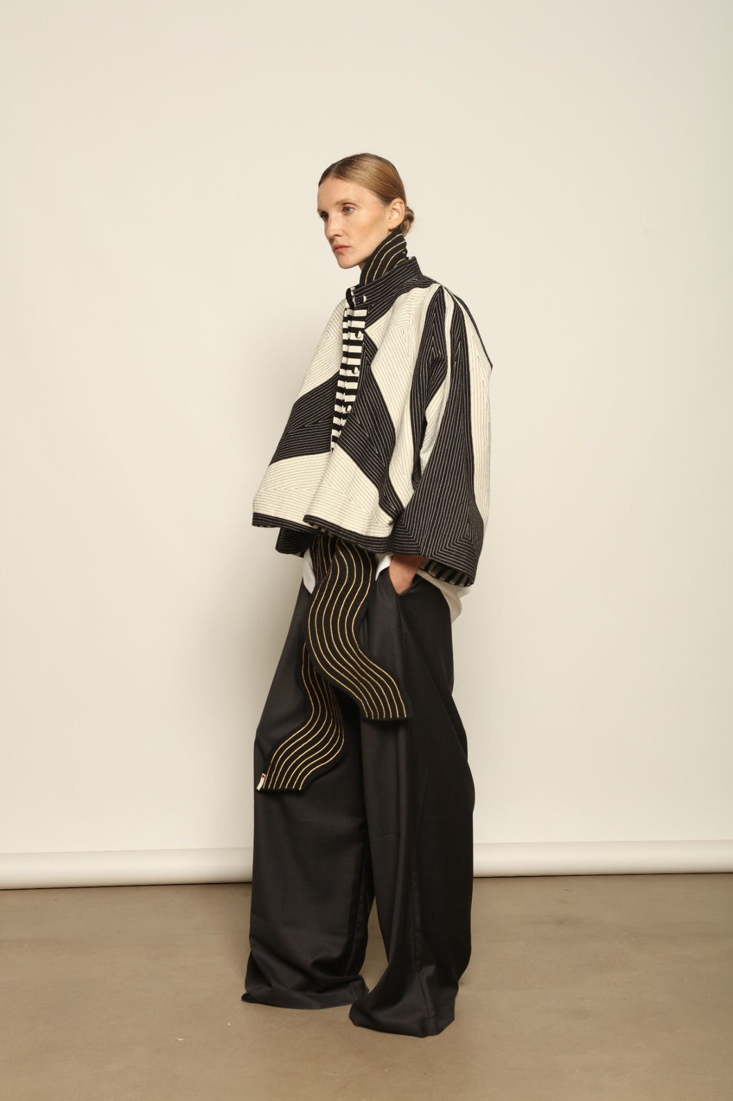 Model is wearing the Tri Crop Moma in black by Ka-Sha, a sculptural heavyweight organic cotton cropped top with geometric panels, curated in the House of Woven Stories selection.
