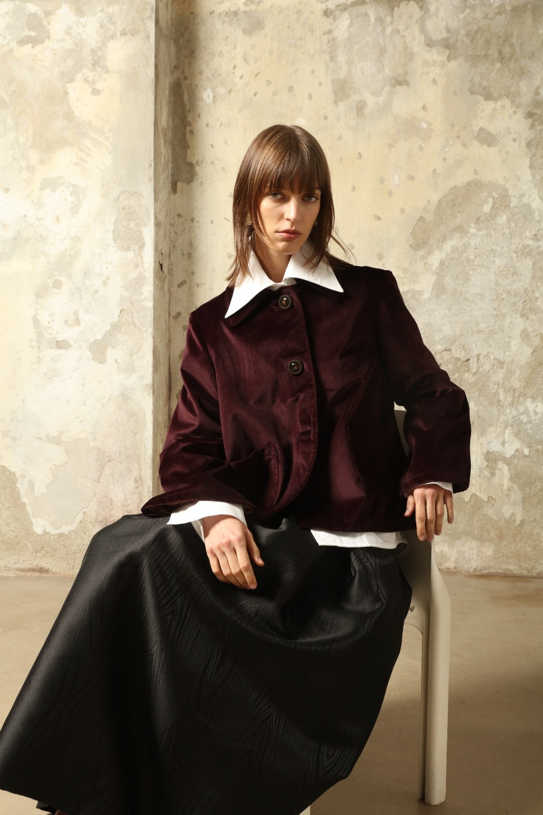 Model is wearing the Katharina Velvet Burgundy Cotton Jacket by House of Woven Stories, crafted from cotton velvet with an A-shape silhouette and hand-printed silk lining.