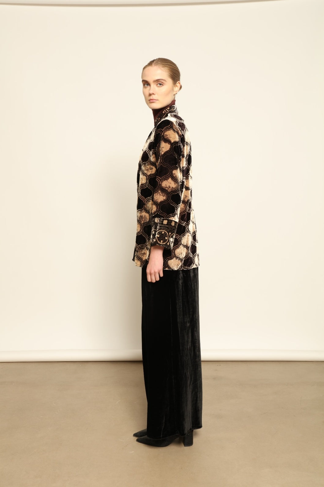 Model is wearing the Kati Black Velvet Trousers by Obidi, crafted from luxurious velvet with a tailored silhouette, combining timeless craftsmanship with modern versatile style.