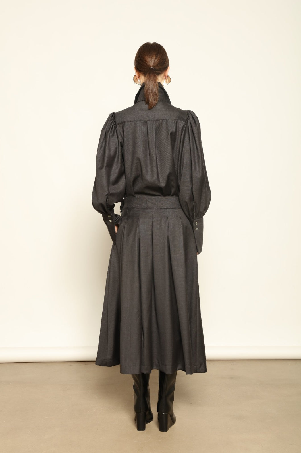 Larissa Super 100% Merino Wool Skirt by House of Nomad Stories – midi-length pleated skirt in soft, luxurious merino wool, tailored in Piemonte, Italy for timeless elegance and comfort.