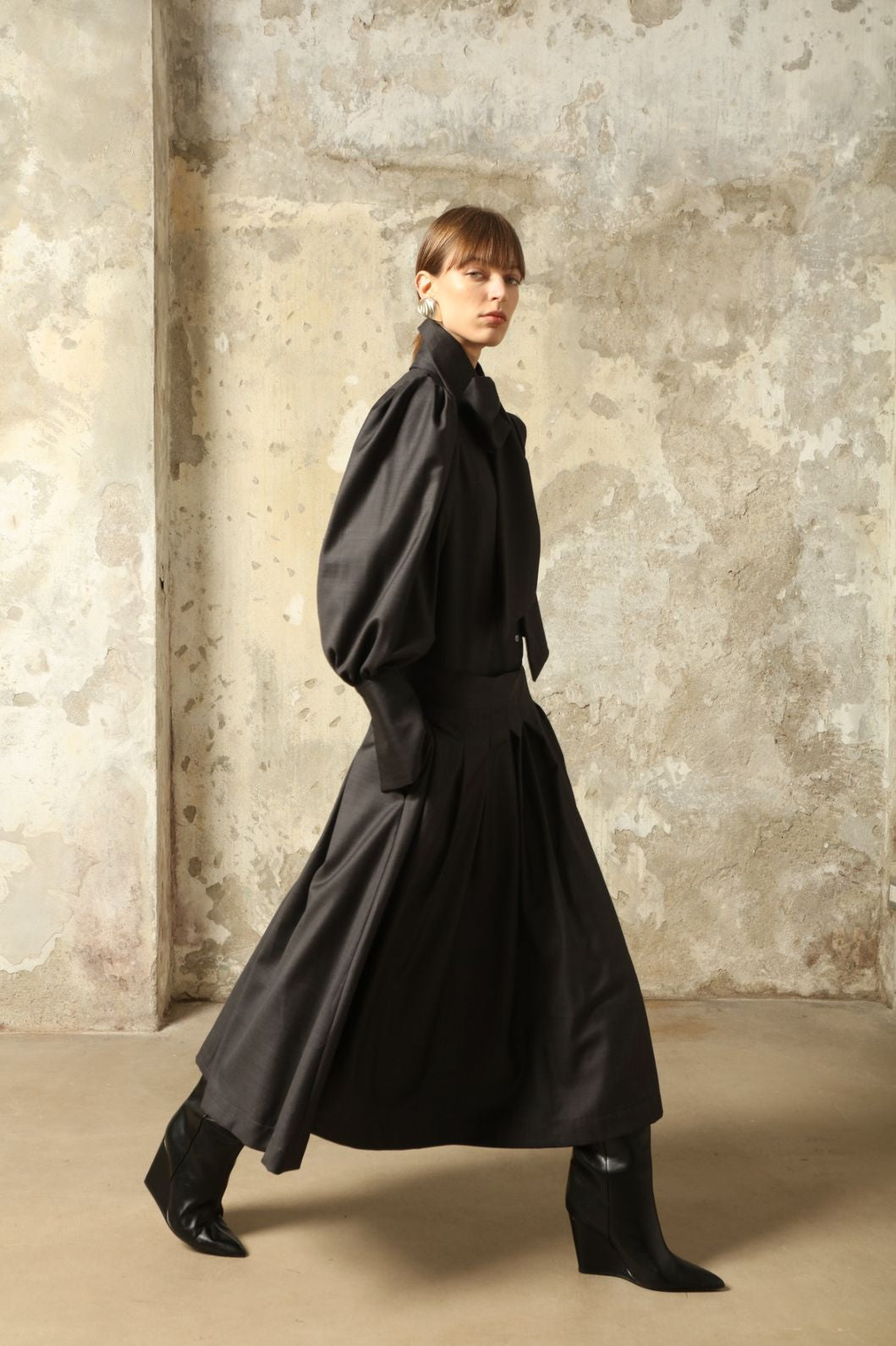 Larissa Super 100% Merino Wool Skirt by House of Nomad Stories – midi-length pleated skirt in soft, luxurious merino wool, tailored in Piemonte, Italy for timeless elegance and comfort.