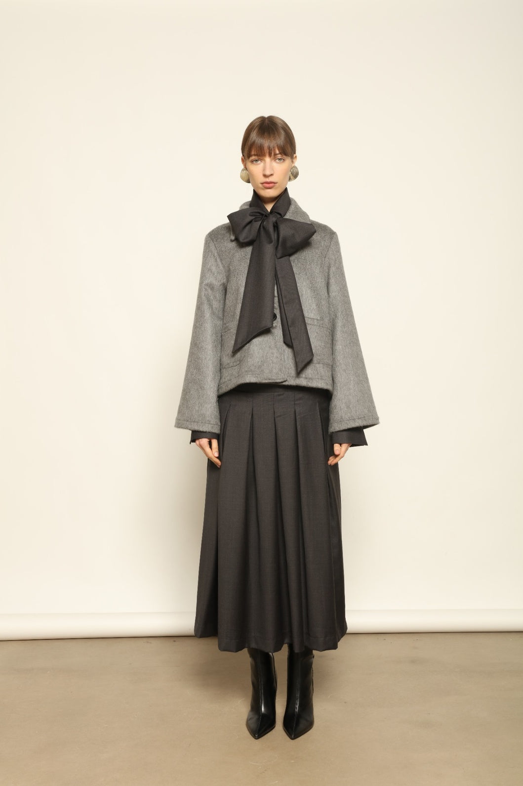 Larissa Super 100% Merino Wool Skirt by House of Nomad Stories – midi-length pleated skirt in soft, luxurious merino wool, tailored in Piemonte, Italy for timeless elegance and comfort.