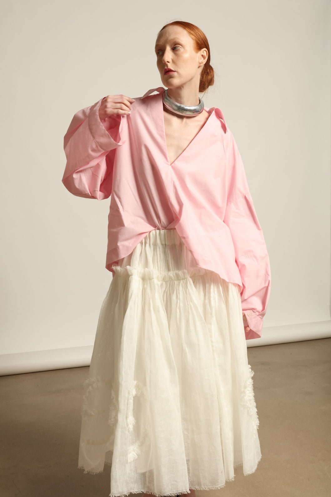 Model is wearing the Les Vacances d’Irina Shell White Skirt, handcrafted from linen with voluminous silhouette and hand-applied ruffles, from the House of Nomad Stories selection.