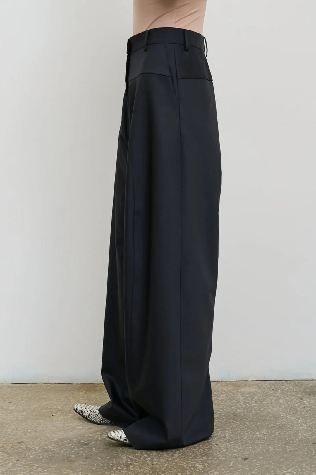 Model is wearing Litkovska high-rise wool wide-leg black pants showcasing contemporary tailoring and designer womenswear at House of Nomad Stories