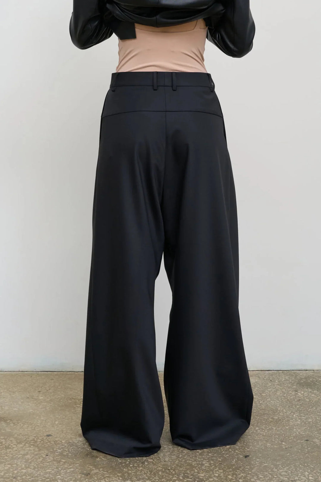 Model is wearing Litkovska high-rise wool wide-leg black pants showcasing contemporary tailoring and designer womenswear at House of Nomad Stories