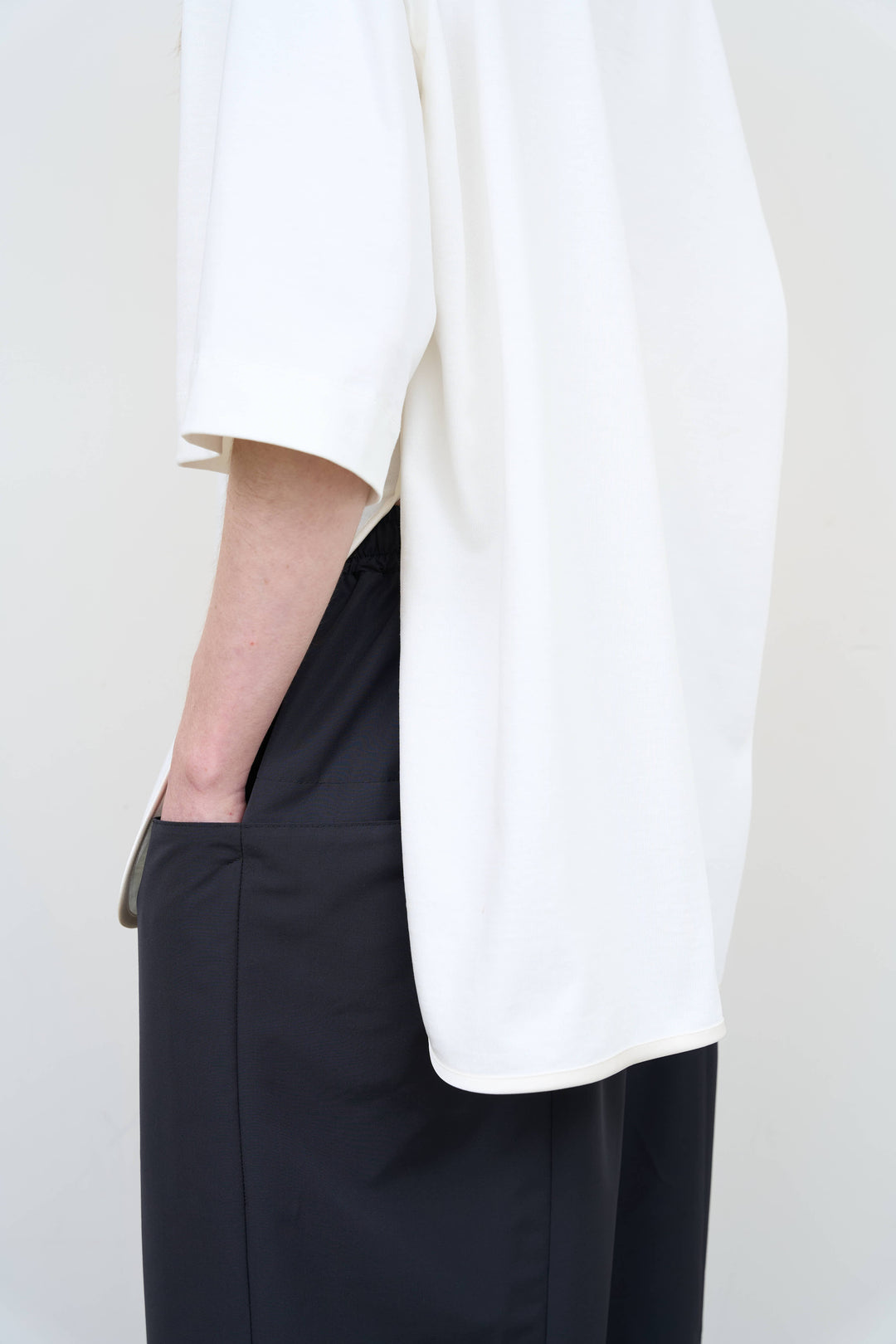 Model is wearing Litkovska corset white T-shirt showcasing tailored waist detail and contemporary designer womenswear at House of Nomad Stories