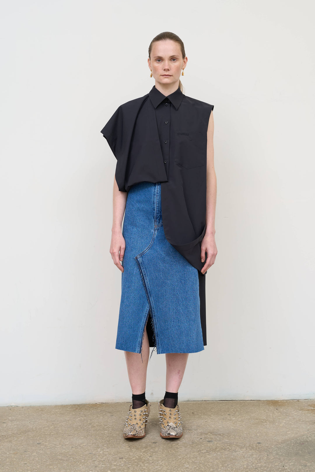 Model is wearing Litkovska black deconstructed wool blend shirt featuring layered tailoring and architectural womenswear design at House of Nomad Stories